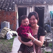 Chinease lady at home holding child