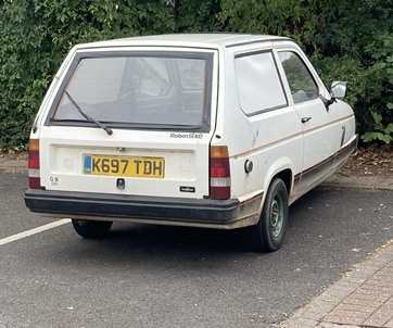 three wheeled car in a car park
